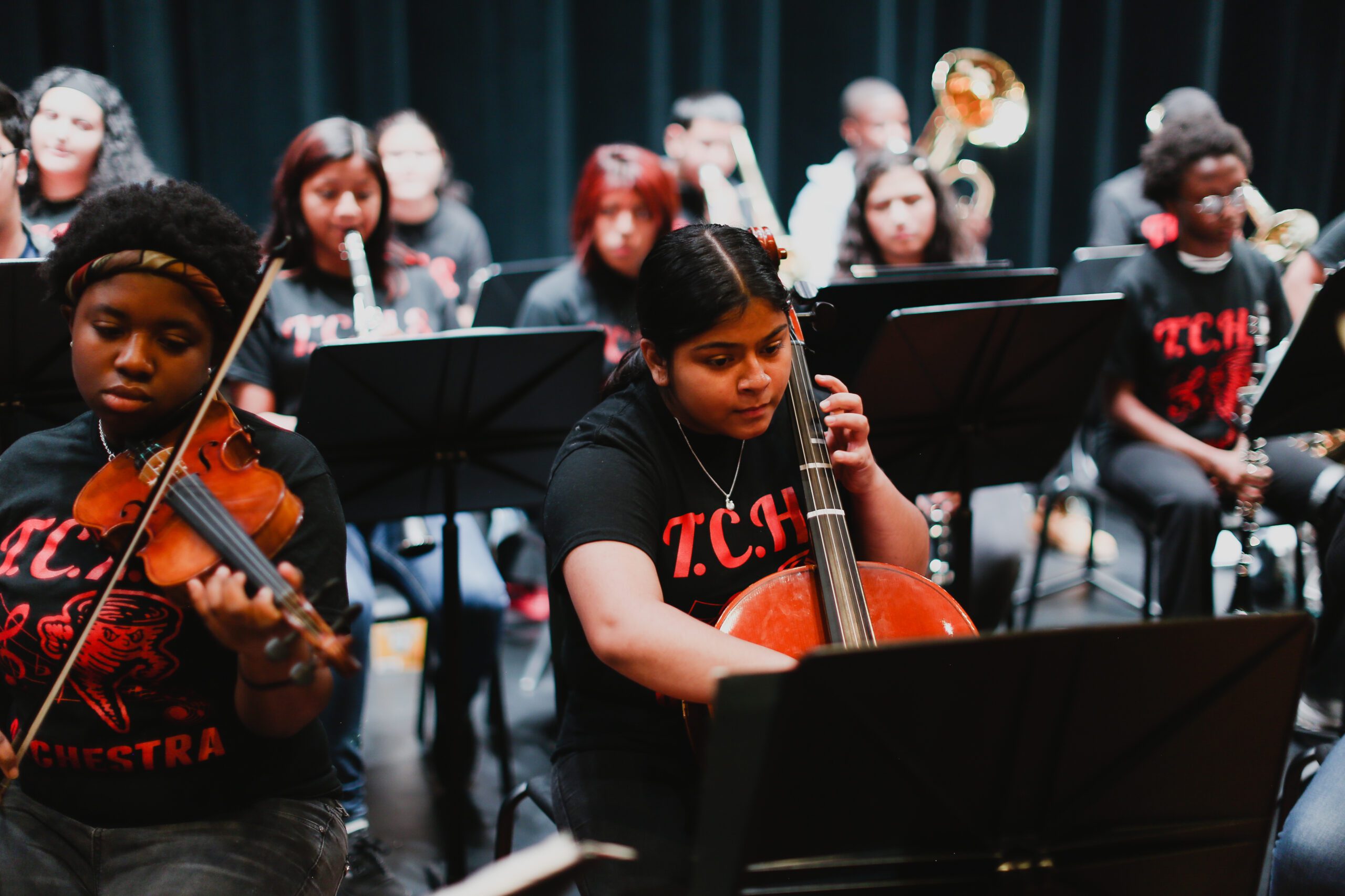 high school students playing instruments in orchestra