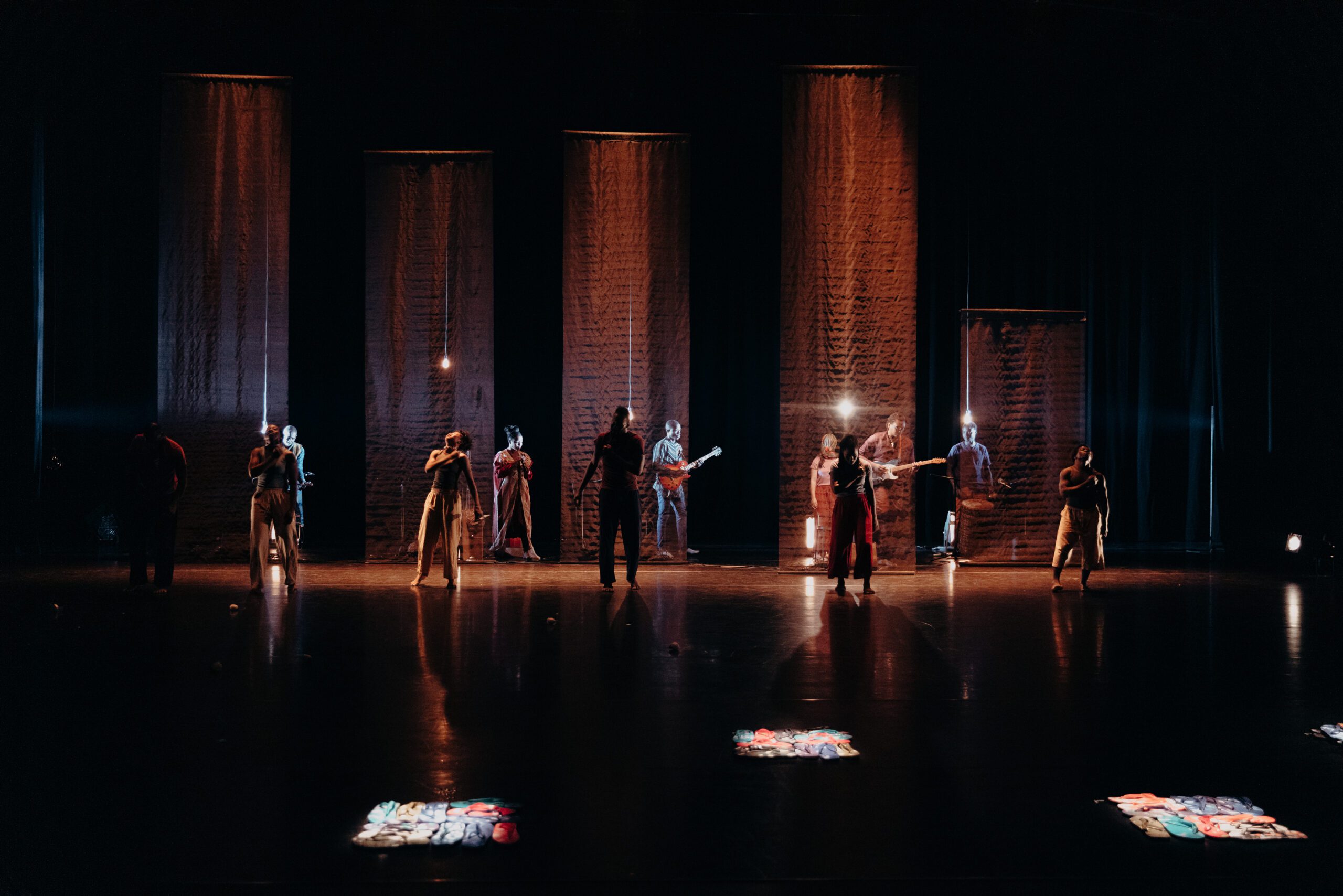 Group of people dancing in a dark room with spotlights