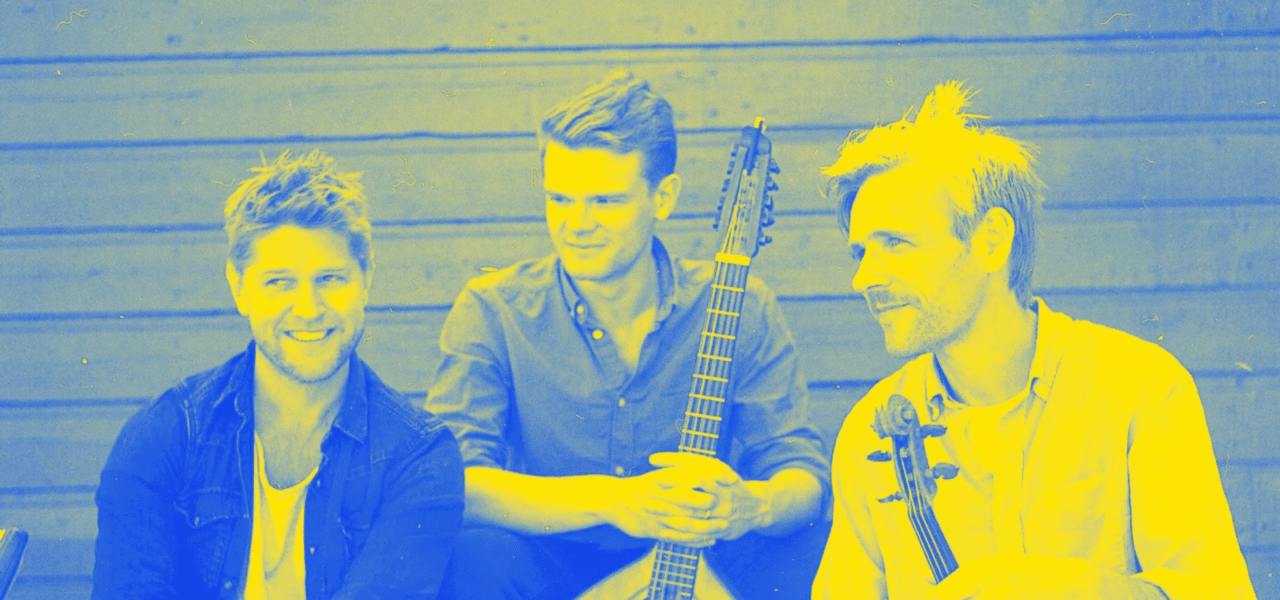 three musicians from Dreamer's Circus smiling off camera